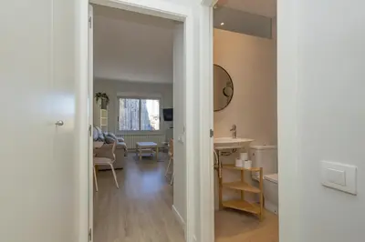 a view of a living room and a dining room at Housalia Sagrada Familia Views in Barcelona