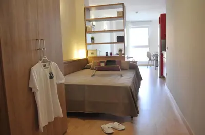 a bedroom with a bed and a mirror on the wall at Alojamientos Universitarios Resa Hipatia in Terrassa