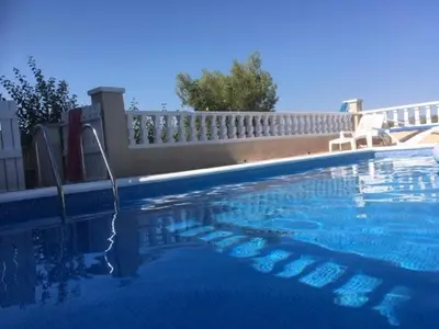 a swimming pool with a hose in the water at CASA DEL BOSQUE CON PISCINA EN SITGES in Sant Pere de Ribes