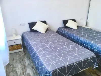 two beds sitting next to each other in a room at CASA DEL BOSQUE CON PISCINA EN SITGES in Sant Pere de Ribes