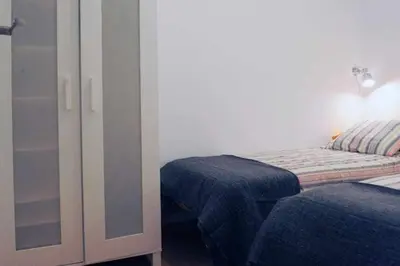 a bedroom with a bed with a lamp and a closet at Calm Modern Apartment in Barcelona