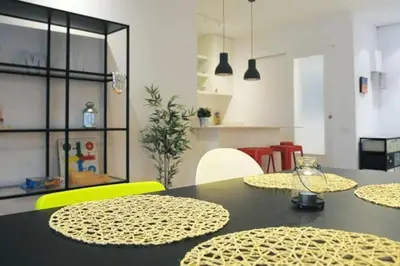 a dining room with a table with yellow chairs at Calm Modern Apartment in Barcelona