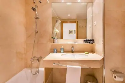 a bathroom with a sink and a tub and a mirror at Fabulous Flat By Paseo De Gracia in Barcelona