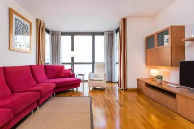 a living room with a red couch and a tv at Fabulous Flat By Paseo De Gracia in Barcelona