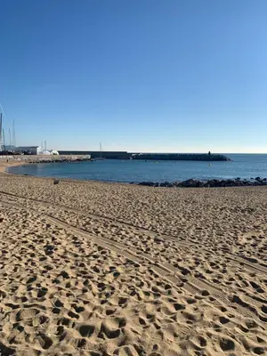 a sandy beach with the ocean in the background at Badalona Beach Apartment in Badalona