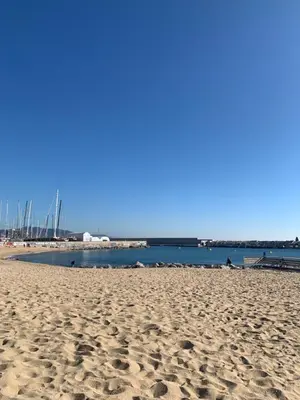 a sandy beach with the ocean in the background at Badalona Beach Apartment in Badalona