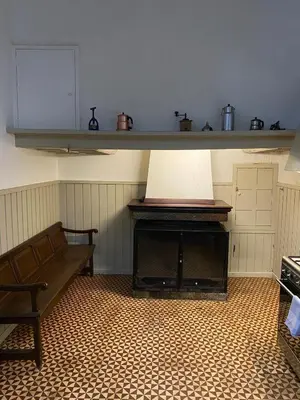 a living room with a table and chairs and a window at Can Martí in Vallgorguina
