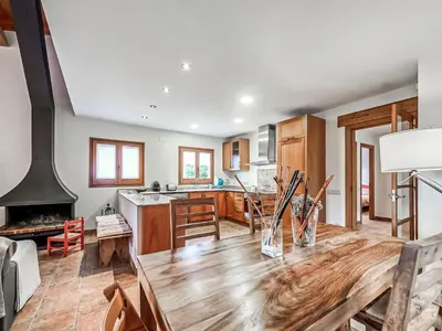 a kitchen with a wooden table and a stove at Holiday Home Montseny with Pool in Montseny