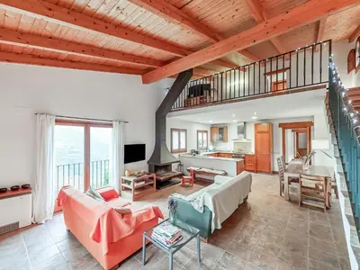 a large living room with a wooden ceiling at Holiday Home Montseny with Pool in Montseny