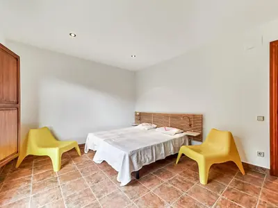 a room with a table and two yellow chairs at Holiday Home Montseny with Pool in Montseny