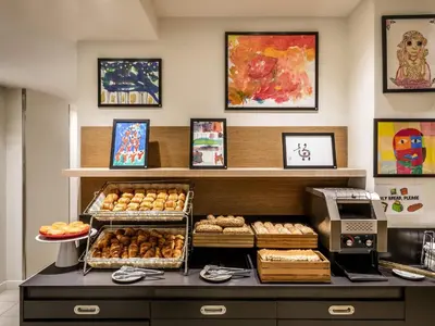 a counter with a table with food on it at ibis Styles Barcelona Centre in Barcelona