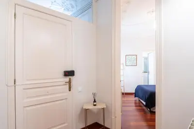 a white door in a room with a bedroom at Modernist apartment in the best location, Eixample in Barcelona