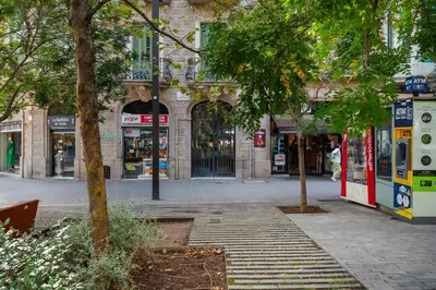 an empty street in a city with stores at Modernist apartment in the best location, Eixample in Barcelona
