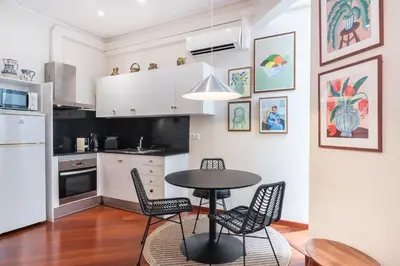 a kitchen with a table and chairs in a room at Modernist apartment in the best location, Eixample in Barcelona