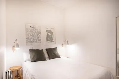a bedroom with a white bed with two pillows at Comfortable Apartment for Groups next to Sagrada Familia, Barcelona in Barcelona