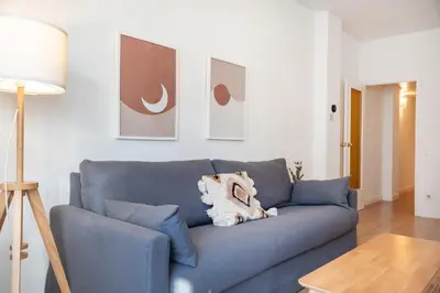 a blue couch with a stuffed animal on it in a living room at Comfortable Apartment for Groups next to Sagrada Familia, Barcelona in Barcelona