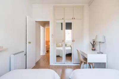 a bedroom with two beds and a desk with a bed at Comfortable Apartment for Groups next to Sagrada Familia, Barcelona in Barcelona