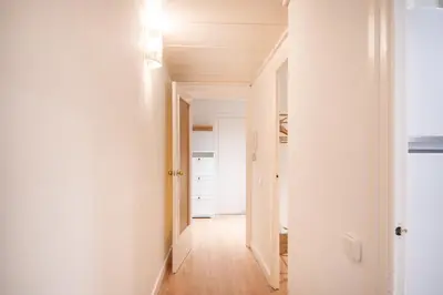 a hallway with white walls and a white door at Comfortable Apartment for Groups next to Sagrada Familia, Barcelona in Barcelona