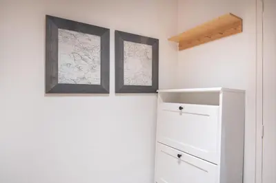 a room with two maps on the wall and a refrigerator at Comfortable Apartment for Groups next to Sagrada Familia, Barcelona in Barcelona