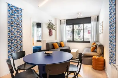 a living room with a table and a couch at Spacious & Comfortable Apartment in Barcelona City Center in Barcelona