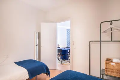 a bedroom with a bed and a desk in a room at Spacious & Comfortable Apartment in Barcelona City Center in Barcelona