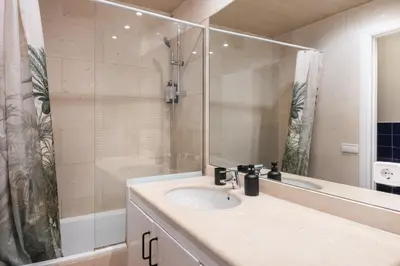 a bathroom with a sink and a shower at Spacious & Comfortable Apartment in Barcelona City Center in Barcelona