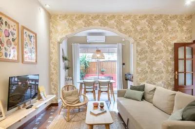 a living room with a couch and a table at Spacious & Sunny Apartment with Terrace in the city center in Barcelona