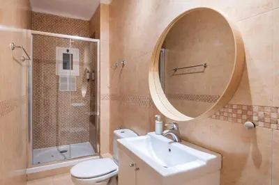 a bathroom with a toilet and a sink and a mirror at Comfortable 3-Bedroom Apartment next to Sagrada Familia, Barcelona in Barcelona