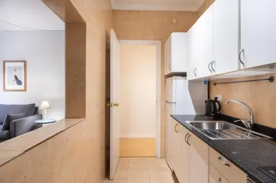 a kitchen with white cabinets and a sink at Comfortable 3-Bedroom Apartment next to Sagrada Familia, Barcelona in Barcelona