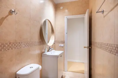 a bathroom with a toilet and a sink and a mirror at Comfortable 3-Bedroom Apartment next to Sagrada Familia, Barcelona in Barcelona