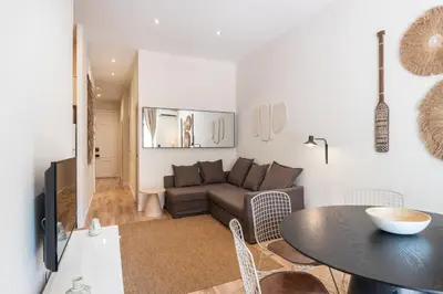 a living room with a couch and a table at Sunny Central Apartment with 100sqm Terrace in Barcelona in Barcelona