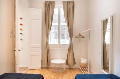 a bedroom with two beds and a window at Sunny Central Apartment with 100sqm Terrace in Barcelona in Barcelona