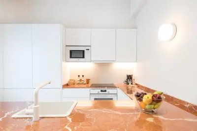 a kitchen with a bowl of fruit on a counter at Mediterranean Retreat with 4-Bedroom, 3-Bath Apartment in Barcelona in Barcelona