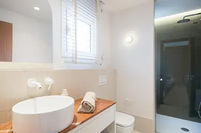 a white bathroom with a sink and a toilet at Mediterranean Retreat with 4-Bedroom, 3-Bath Apartment in Barcelona in Barcelona