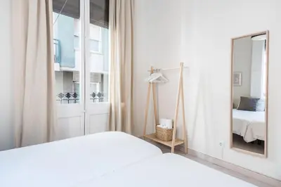 a white bedroom with a mirror and a bed at Cozy Apartment with Terrace in Gracia, Barcelona Local Life in Barcelona