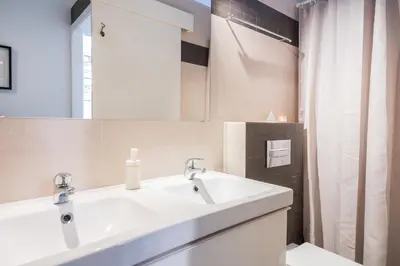 a bathroom with a white sink and a shower at Cozy Apartment with Terrace in Gracia, Barcelona Local Life in Barcelona