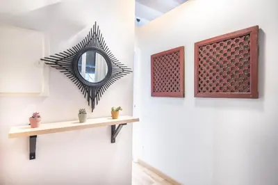 a hallway with a mirror and a shelf at Oasis with a terrace in the heart of Gracia, Barcelona in Barcelona
