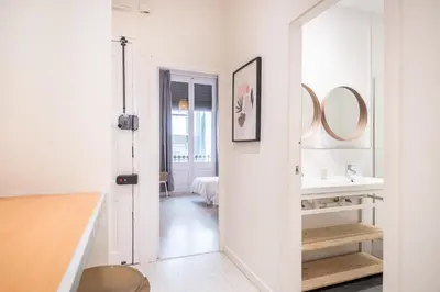 a white bathroom with a sink and a mirror at Sunny Terrace Apartment in Gracia, Barcelona - Local Lifestyle in Barcelona