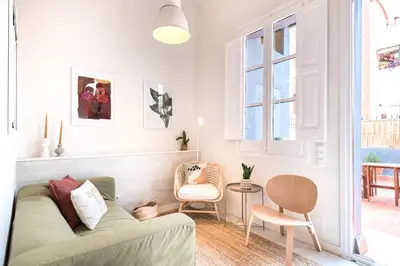 a living room with a couch and a chair at Sunny Apartment with Private Terrace in Gracia, Barcelona in Barcelona