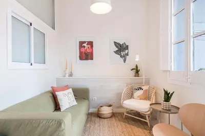 a living room with a couch and a chair at Sunny Apartment with Private Terrace in Gracia, Barcelona in Barcelona