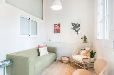 a living room with a couch and a chair at Sunny Apartment with Private Terrace in Gracia, Barcelona in Barcelona