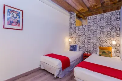two beds in a room with white walls at Charming 3 Bdr-2 Bthr In Gracia in Barcelona