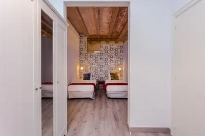 a room with two beds and a hallway with doors at Charming 3 Bdr-2 Bthr In Gracia in Barcelona