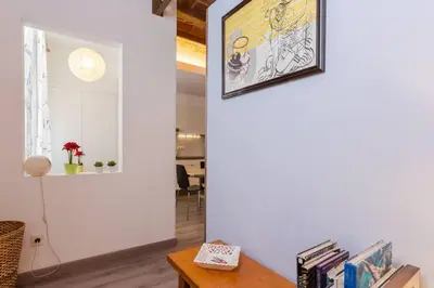 a living room with a table and a mirror at Charming 3 Bdr-2 Bthr In Gracia in Barcelona
