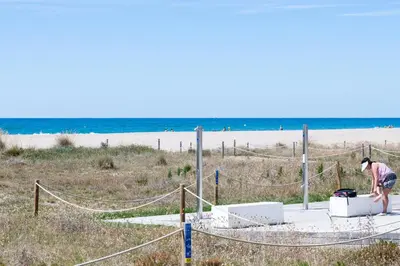 a woman standing on top of a net at the beach at Maka beach apartment v in Castelldefels