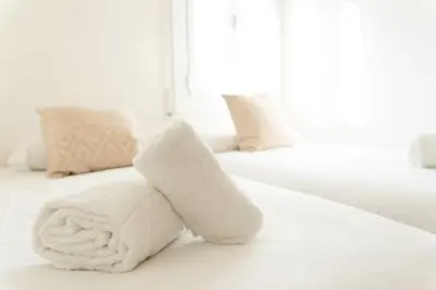 a towel animal made out of towels sits on a bed at Maka beach apartment v in Castelldefels