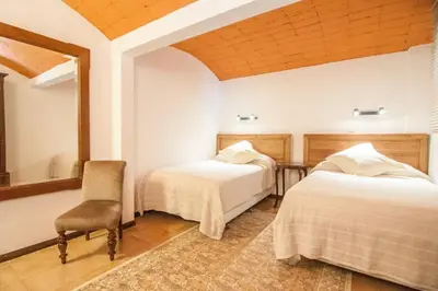 a bedroom with two beds and a chair in it at Magic Place in Barcelona