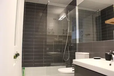 a bathroom with a shower with a toilet and a sink at Piso nuevo al lado de la Sagrada Familia. in Barcelona