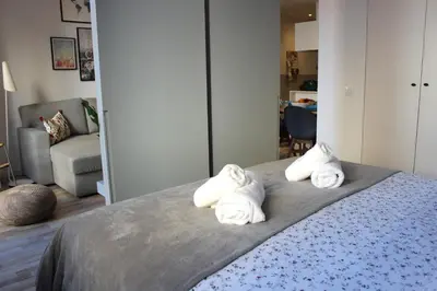 a room with a bed with towels on it at Piso nuevo al lado de la Sagrada Familia. in Barcelona