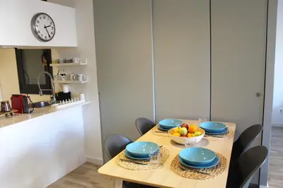 a dining room table with blue plates and a bowl of fruit at Piso nuevo al lado de la Sagrada Familia. in Barcelona